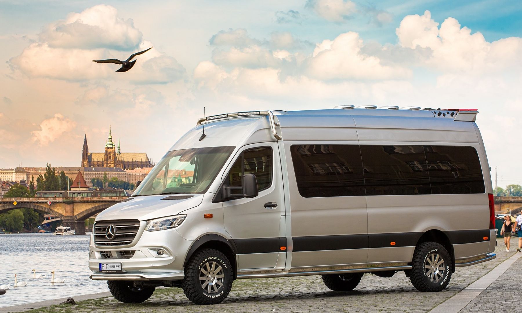 VIP Sprinter 4×4 on the Prague riverfront, Prague Castle behind it